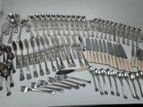 a lot of silver spoons and forks on the table