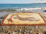 a picture of a painting on a rock on the beach