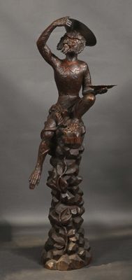bronze statue of a woman holding a child on her lap