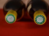 two bottles of wine that are sitting on a table