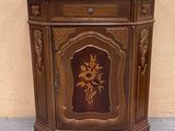 a small wooden cabinet with a flower design on it