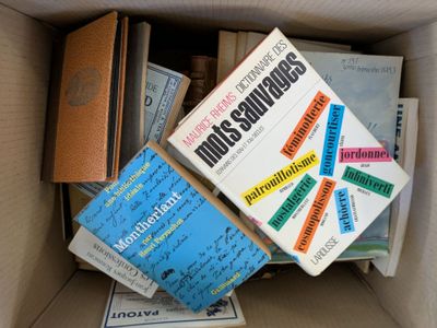 many books in a box that are sitting on top of each other
