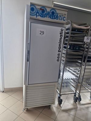 an image of a refrigerator in a store with a cart in front of it