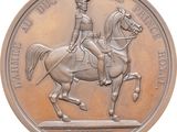 an image of a bronze medal depicting a man on a horse