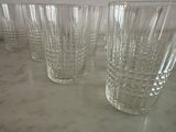 six glasses sitting on a table with a white background