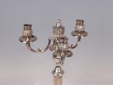 a silver candelab with three candles on it