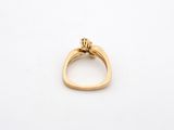 a close up of a gold ring on a white surface