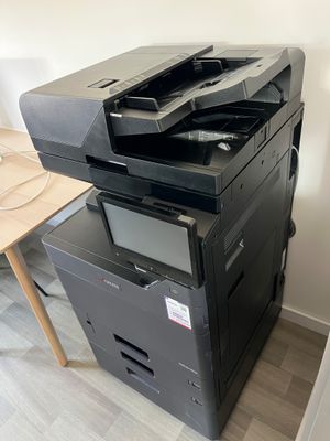 a black printer sitting on top of a stack of boxes
