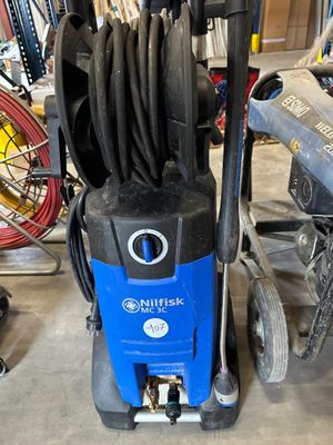 an image of a blue and black power washer in a garage