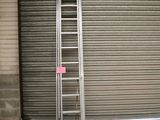 a ladder leaning against a garage door in front of a garage door