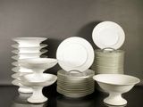 a lot of plates and bowls on the table