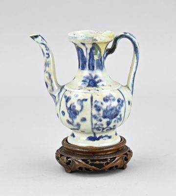 a blue and white vase sitting on a wooden stand