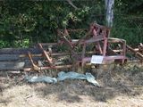 an old rusty plow sitting in the middle of a field