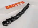 a black chain that is laying on a white surface