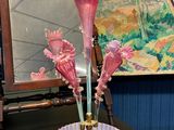 un vase en verre contenant des fleurs roses, posé sur une table