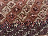 a brown and blue rug with a pattern on it