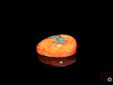 une orange posée sur une surface noire