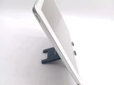 a white tablet computer sitting on a stand on a table