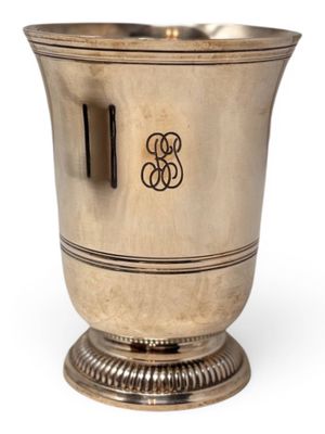 an antique silver wine cooler with a monogram on the side
