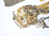 a lot of gold and silver jewelry on a white table