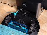 a robot that is sitting on a table with a blue towel