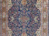a blue rug with a medallion design on it
