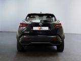 the back of a black nissan suv parked in a white room