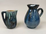 two vases sitting next to each other on a table