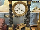 a black and gold clock sitting on top of a table
