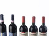 several bottles of wine are lined up in a row on a table