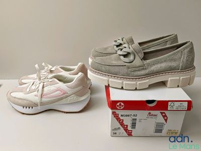 two pairs of women ' s shoes sitting on top of a box