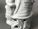 a figurine of a woman holding a candle
