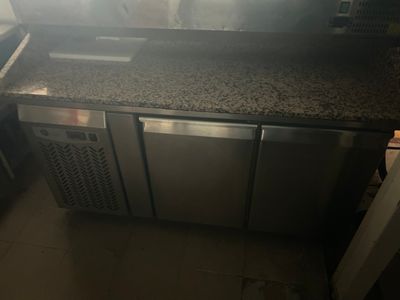 a kitchen with a stove, sink, and refrigerator in it