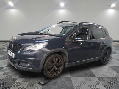 the blue car is parked on a checkered floor in the garage