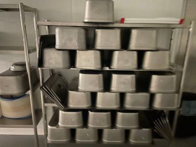 many pans on the shelf in the kitchen