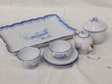 several pieces of blue and white porcelain on a white table cloth