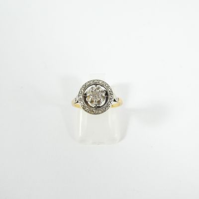 a close up of a diamond ring on a white surface