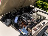 a car with its hood open and the engine in the trunk