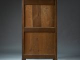 a wooden cabinet with a drawer on top of it in a dark room