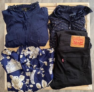 three pieces of clothing are laid out on a wooden crate
