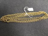 a close up of a gold chain with a tag on it
