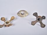 two pieces of metal are sitting next to each other on a white surface