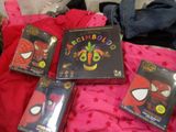 four dvd ' s on a bed with a red blanket