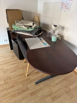 a desk with a chair and a computer on it