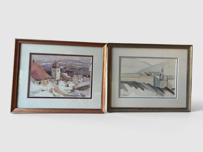 two framed pictures of buildings and a church on a snowy day