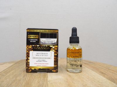 an image of a bottle of cannabis oil next to a box on a table