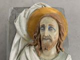 a statue of jesus with a yellow hat on it ' s head