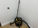 a vacuum that is sitting in the corner of a room