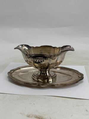 a silver plate with a saucer and a saucer on it