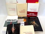 several books are stacked on top of each other on a white surface
